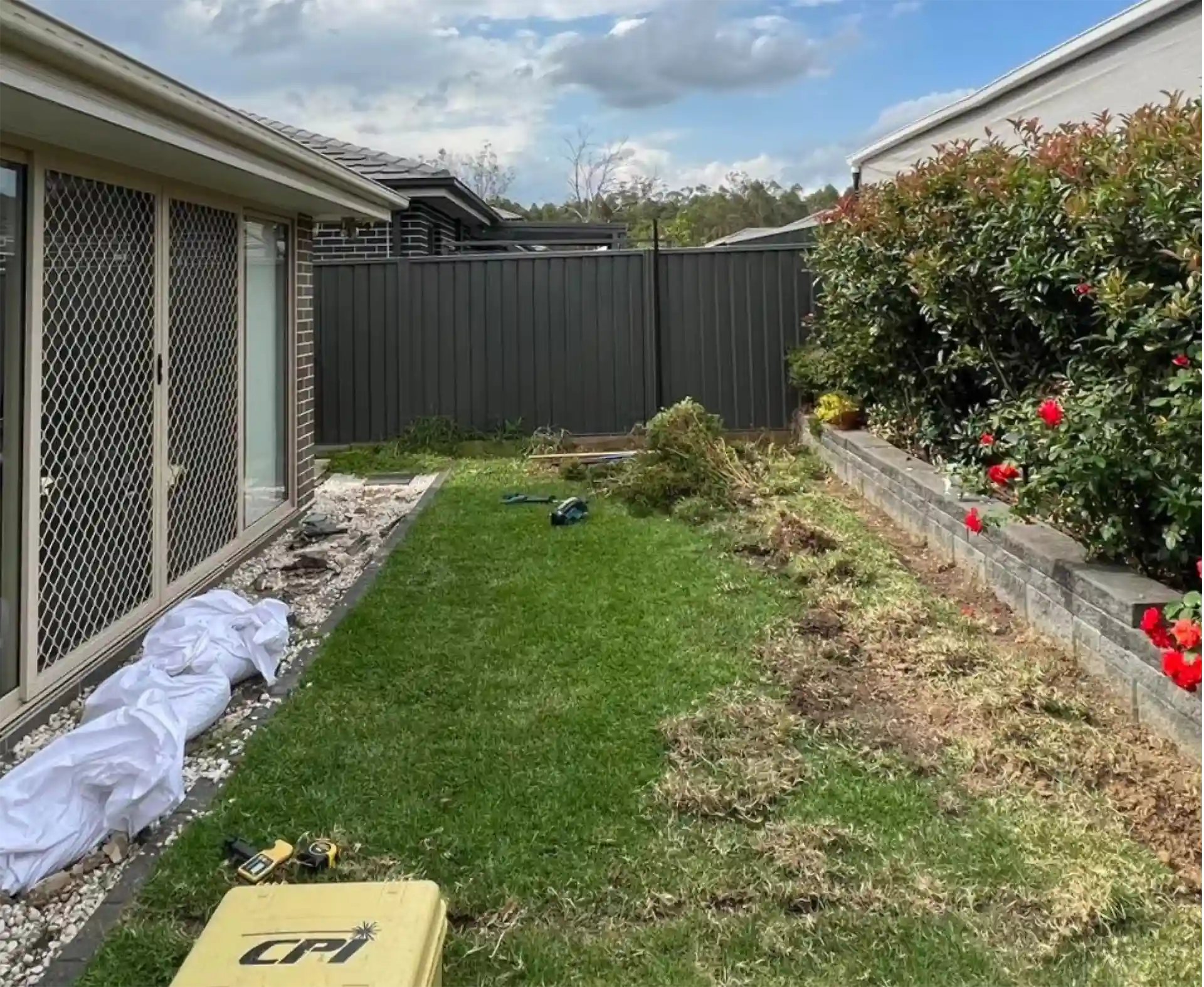 Backyard before a new deck by Ballard's Carpentry