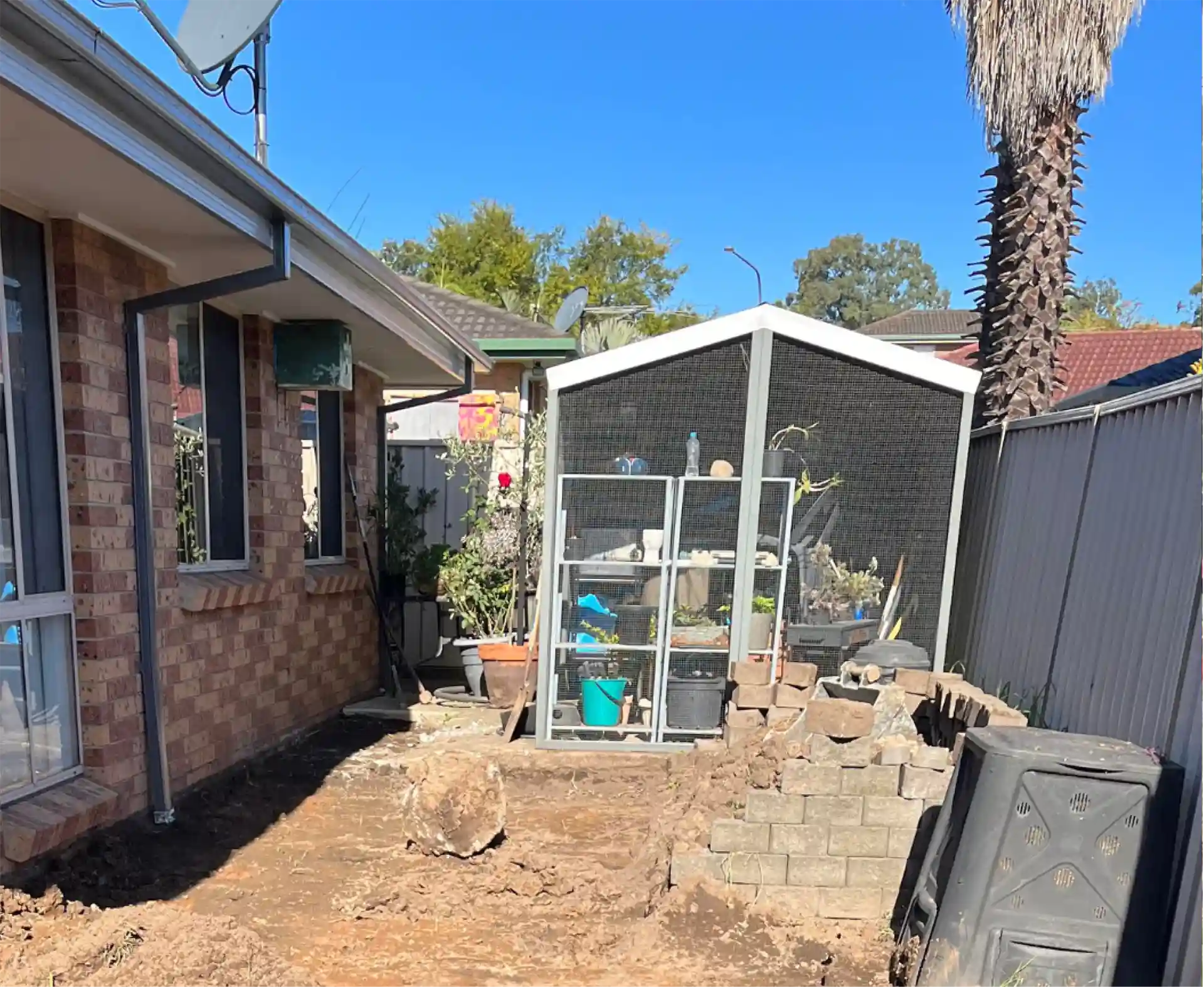 Yard before an outdoor living build by Ballard's Carpentry